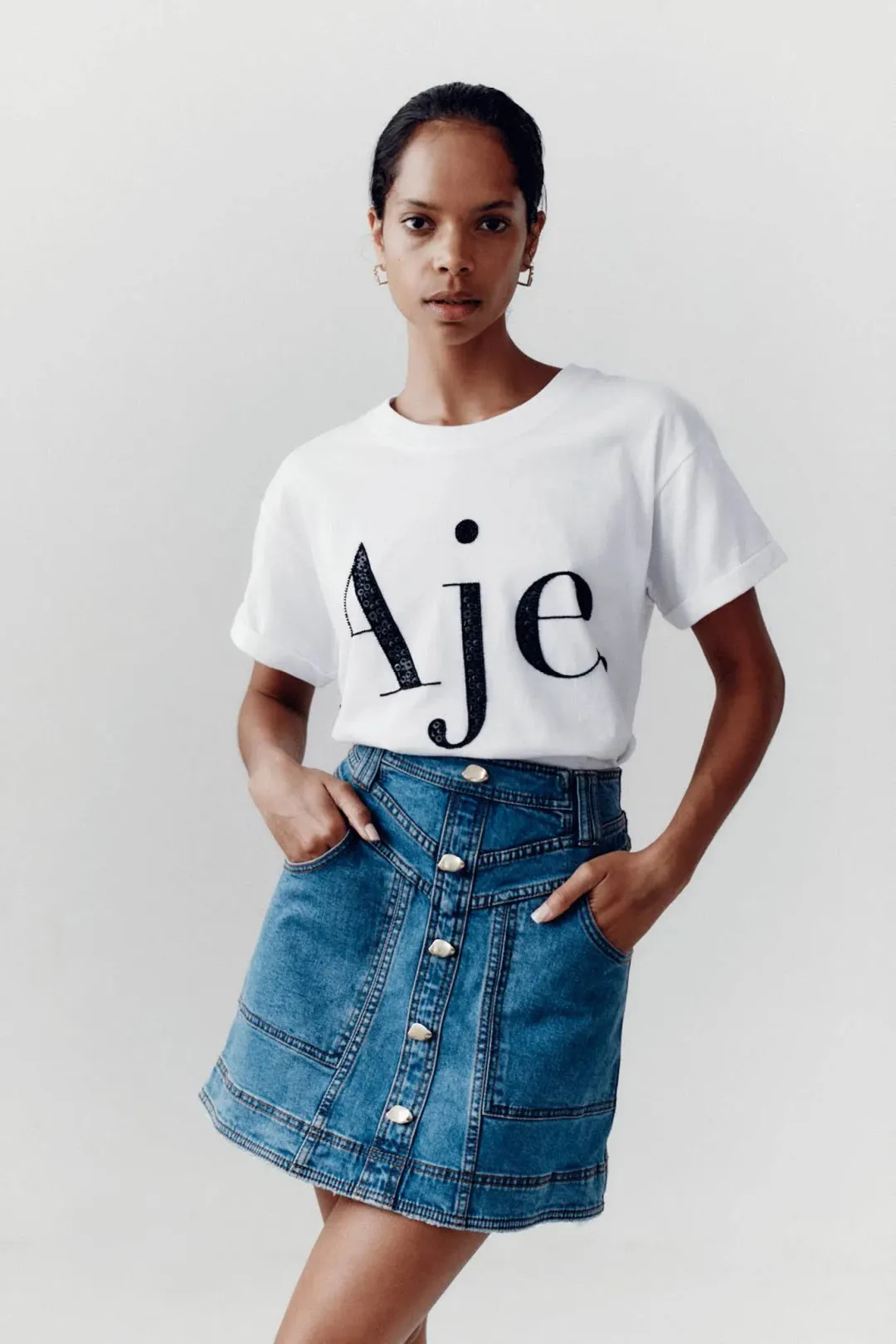Aje Belmond Mini Skirt in Denim Blue Size 8 and Logo Tee White Print Size 6 Set for rent on The Volte - main image