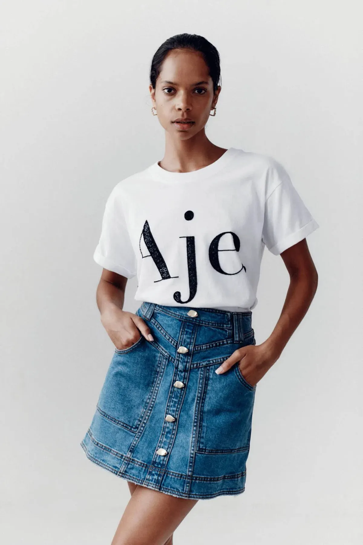 Aje Belmond Mini Skirt in Denim Blue Size 8 and Logo Tee White Print Size 6 Set for rent on The Volte - main image