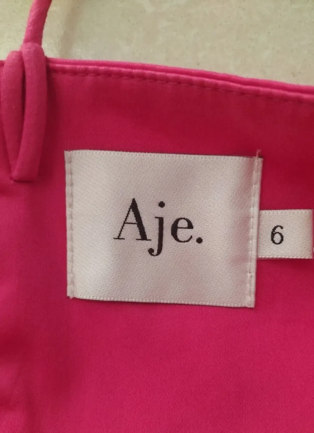 AJE Maya Tiered Mini Dress Fuchsia with side pockets AU 6 US 2 for rent on The Volte - main image