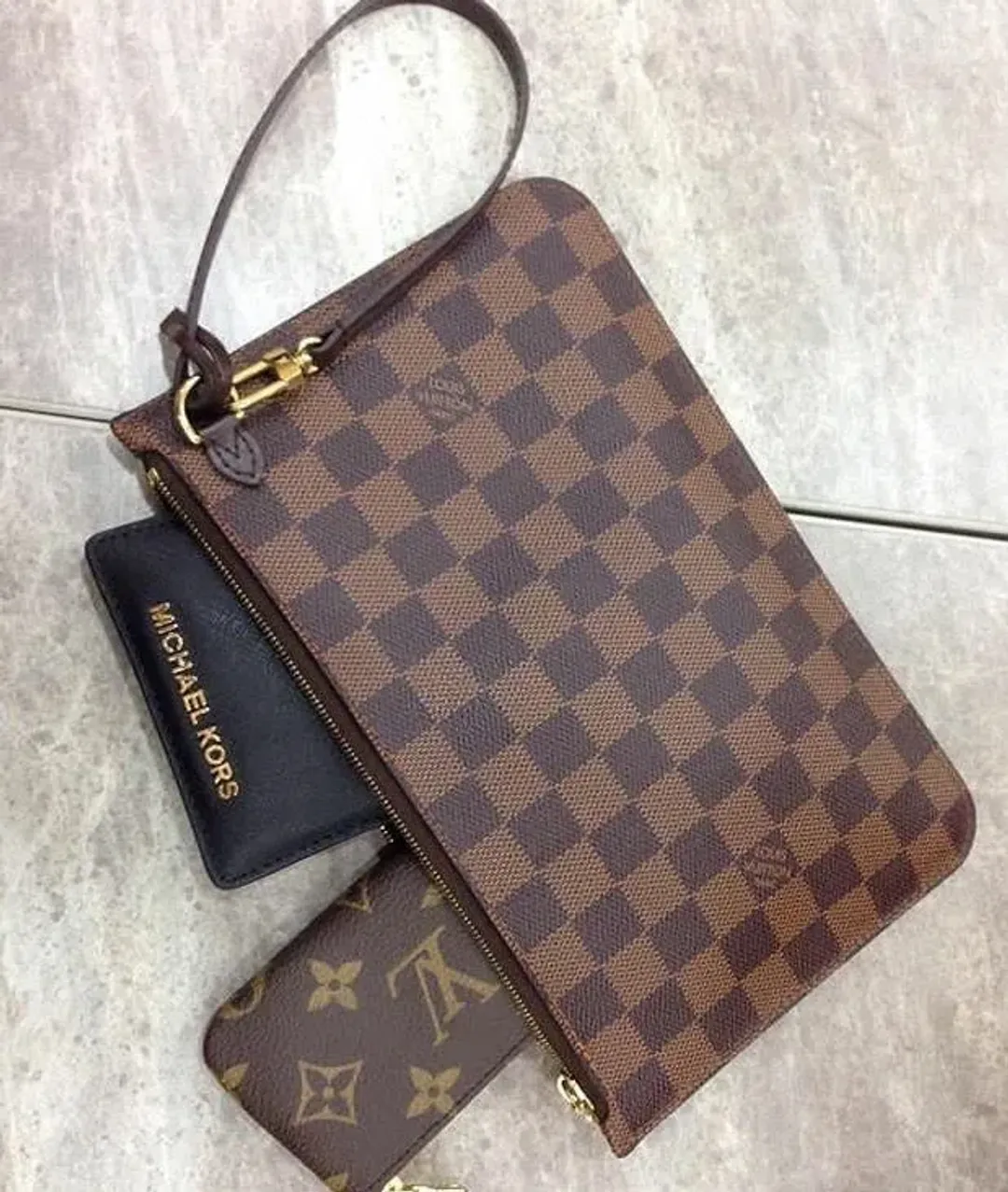 Louis Vuitton Neverfull Damier Wristlet for rent on The Volte - main image